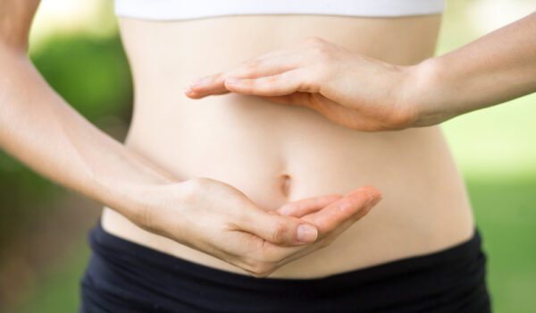 woman with hands positioned in front of her stomach